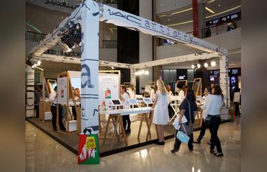 Women try out expert makeup techniques at DSFs MAC Instant Artistry 